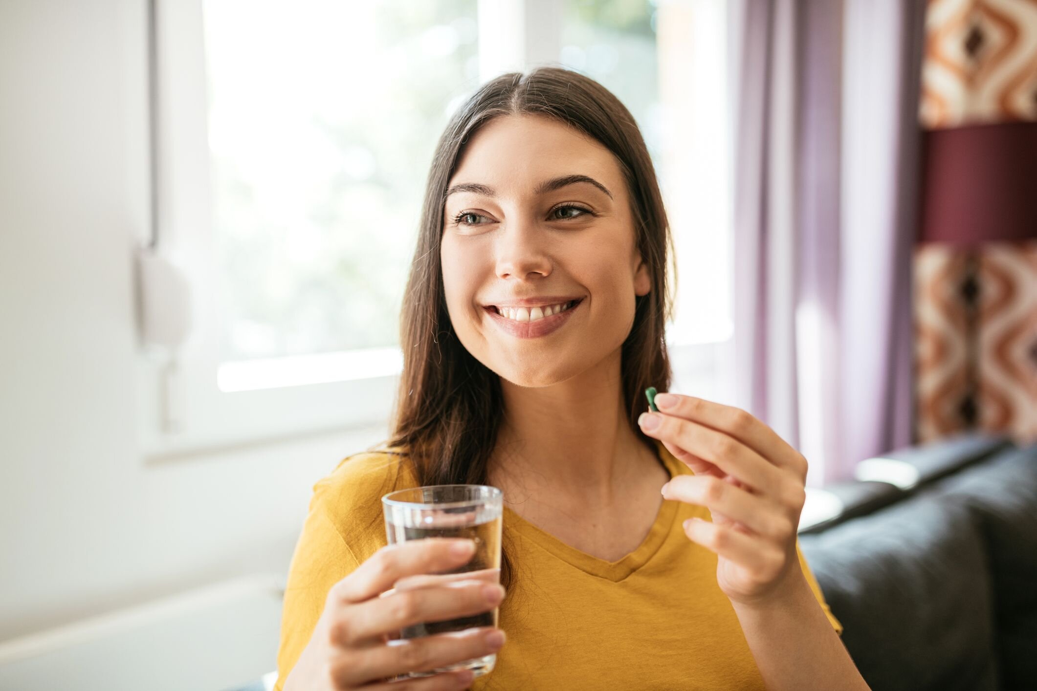 healthy-young-woman-taking-herbal-supplements-royalty-free-image-1663192814